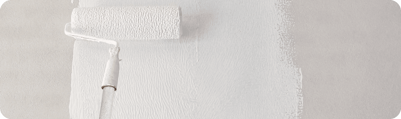 Paint roller applying a fresh coat